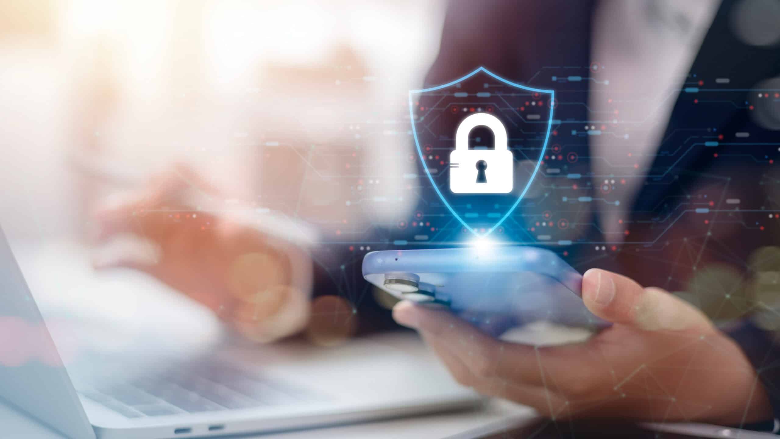 A man holds a phone with a digital padlock above it.